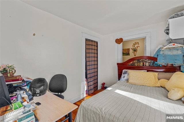 bedroom with hardwood / wood-style flooring