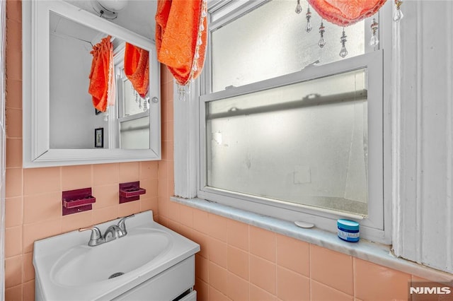 bathroom featuring tile walls and vanity