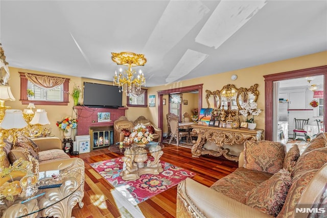 living room featuring wood-type flooring and a chandelier