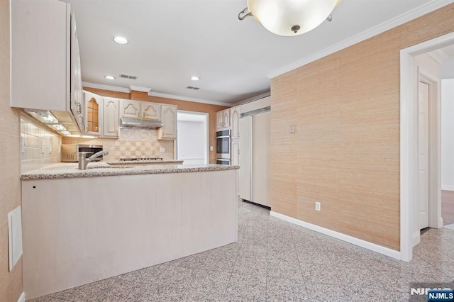 kitchen featuring crown molding, kitchen peninsula, paneled fridge, oven, and decorative backsplash