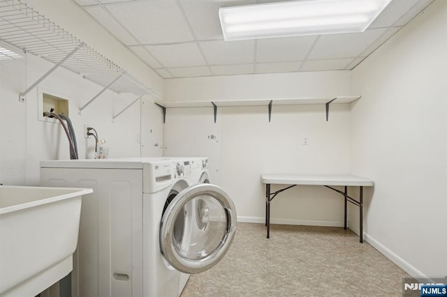 clothes washing area featuring sink and washer and clothes dryer