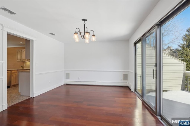 unfurnished dining area with a baseboard radiator, dark wood-type flooring, sink, and a notable chandelier