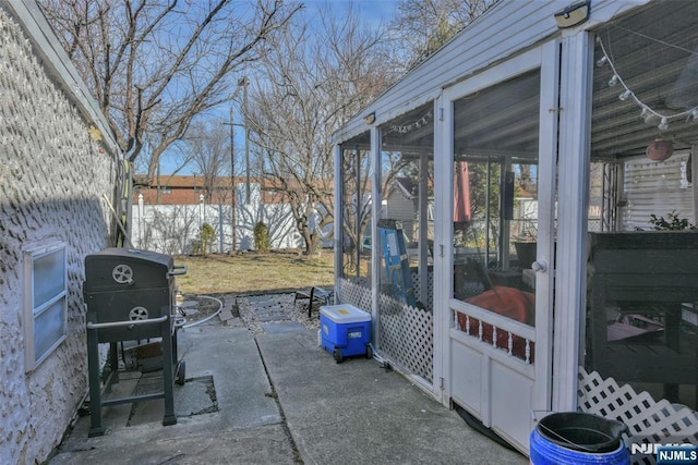 view of patio / terrace with grilling area and a sunroom