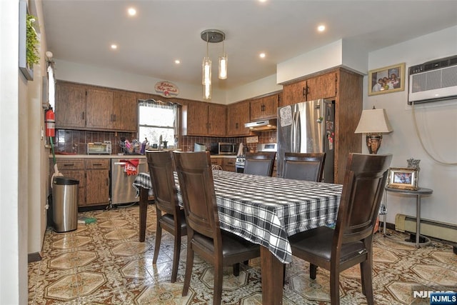 dining space with an AC wall unit and a baseboard heating unit