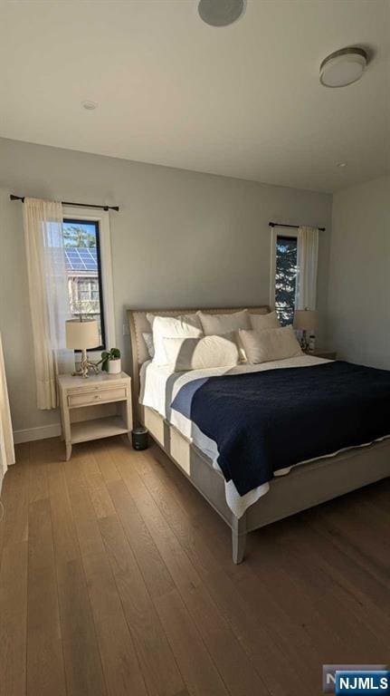 bedroom with hardwood / wood-style flooring