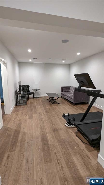 exercise room featuring hardwood / wood-style floors