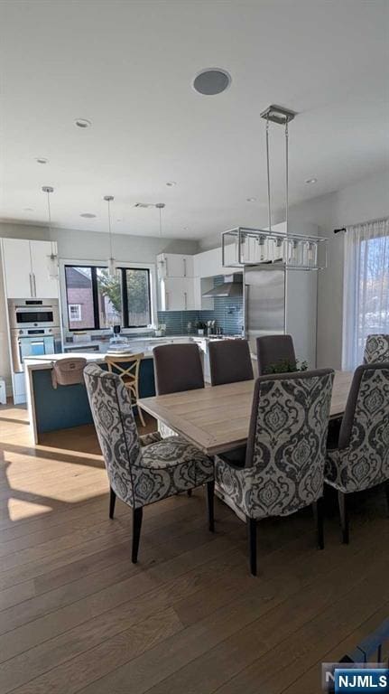 dining area with hardwood / wood-style floors