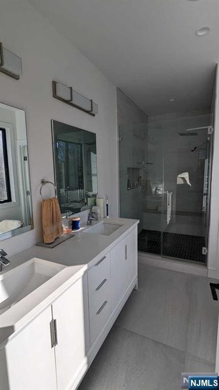 bathroom with vanity, an enclosed shower, and tile patterned flooring