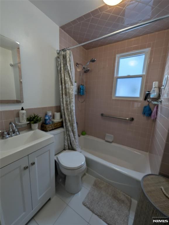 full bathroom with vanity, shower / bath combination with curtain, tile patterned floors, and toilet