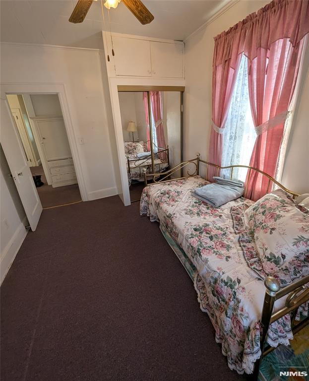 carpeted bedroom with ceiling fan