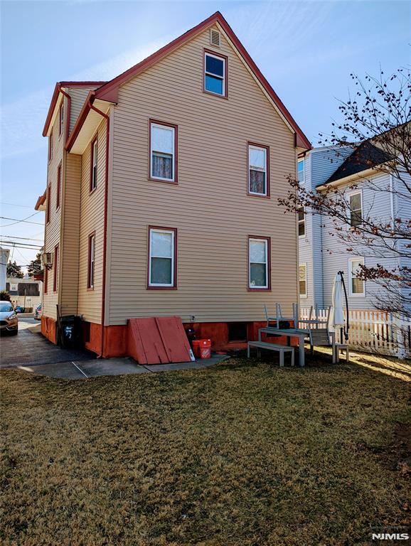 back of property featuring a lawn