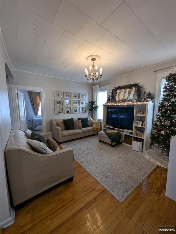 living room featuring wood-type flooring and a notable chandelier