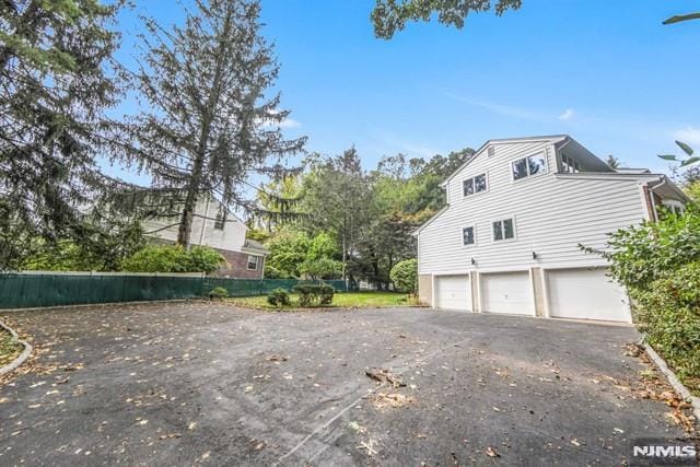 view of side of home featuring a garage