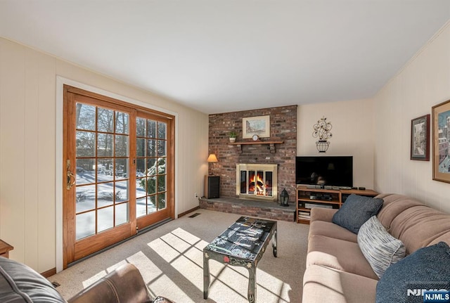 carpeted living room with a fireplace