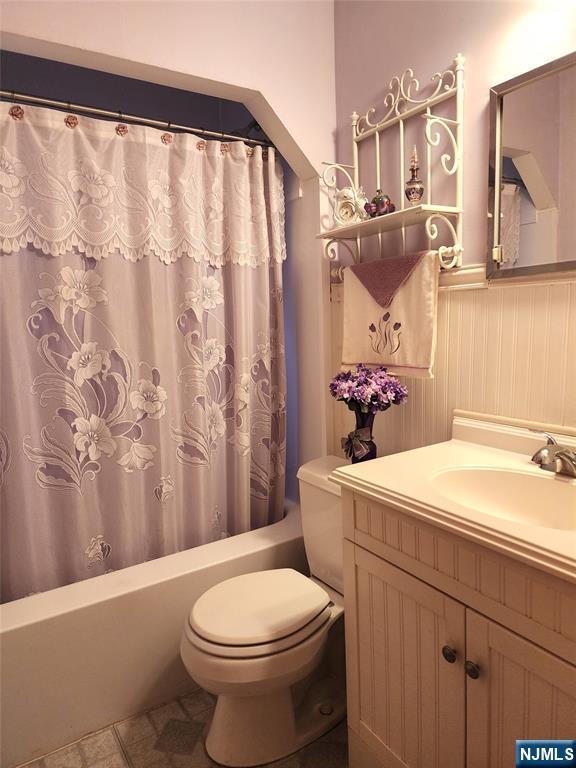 bathroom featuring vanity, toilet, and tile patterned flooring