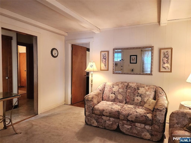 living room featuring beamed ceiling and carpet flooring