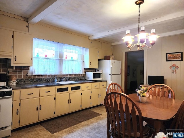 kitchen with sink, beamed ceiling, white appliances, and cream cabinetry