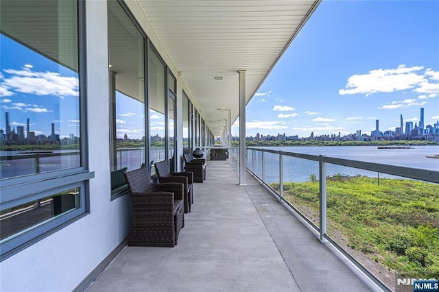 balcony featuring a view of city and a water view