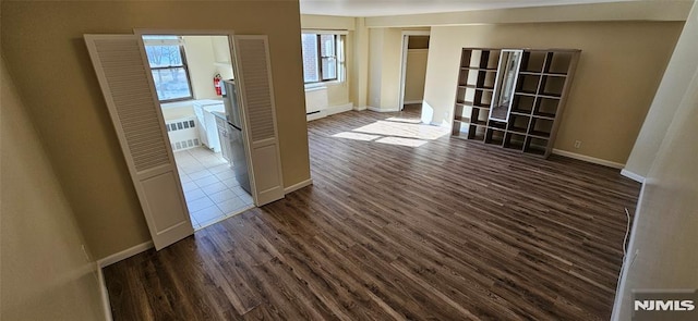 spare room featuring dark hardwood / wood-style flooring