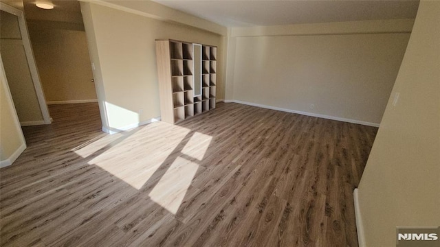 spare room featuring dark wood-type flooring