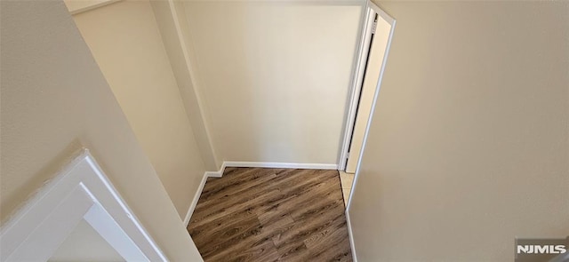 corridor with dark wood-type flooring