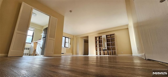 spare room with wood-type flooring