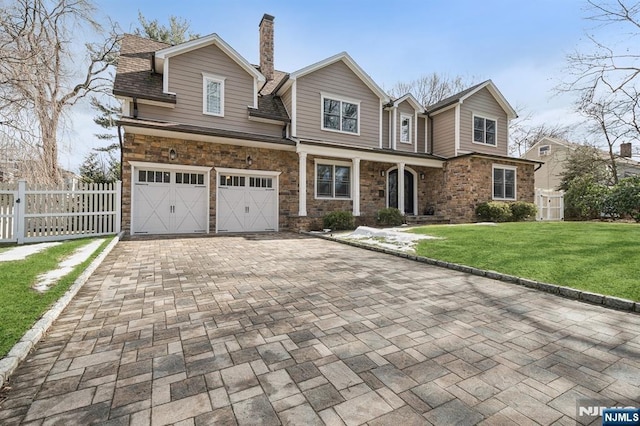 view of front of property featuring a garage and a front yard