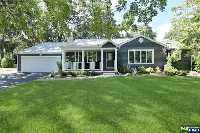 ranch-style house with a garage, a front yard, and a porch