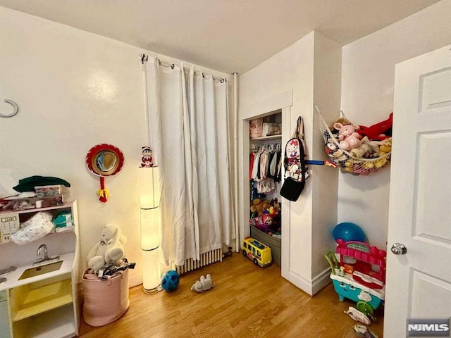 playroom with hardwood / wood-style flooring