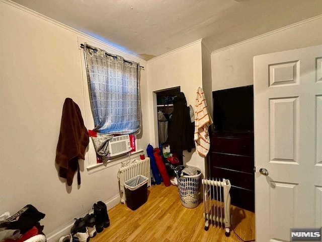 bedroom featuring radiator heating unit and light hardwood / wood-style flooring