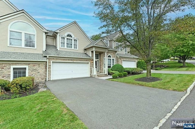 view of front of home featuring a garage and a front yard