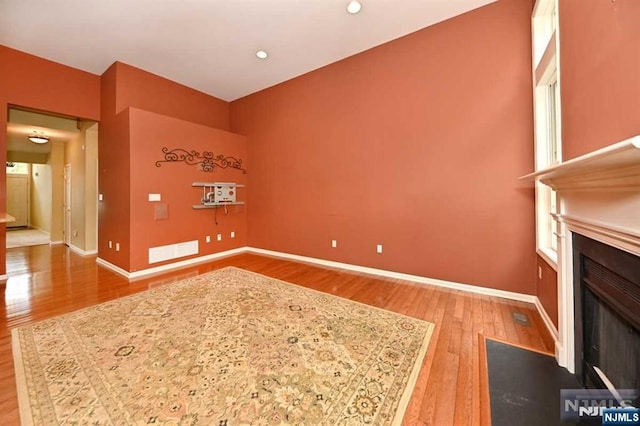 unfurnished living room with wood-type flooring