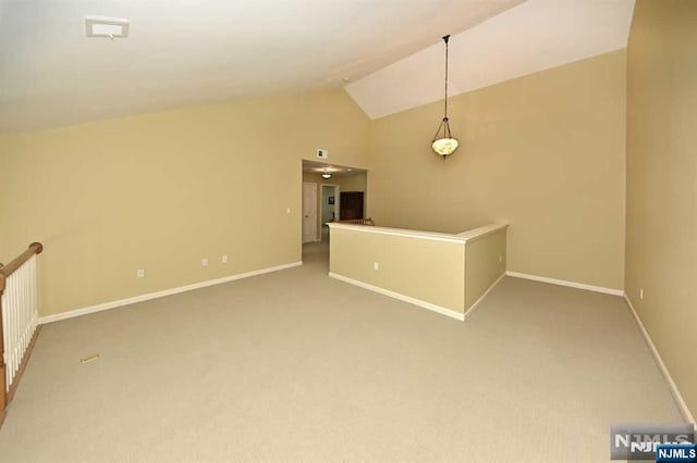 interior space featuring carpet flooring and vaulted ceiling