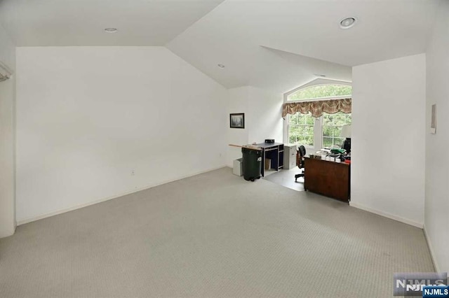 office area with light colored carpet and lofted ceiling