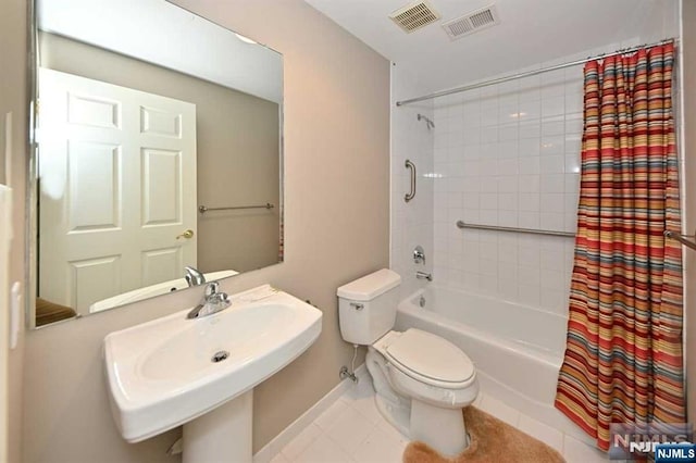 full bathroom with sink, tile patterned floors, toilet, and shower / bath combo with shower curtain