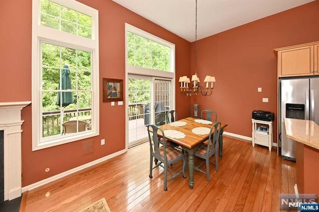 dining space with an inviting chandelier and light wood-type flooring