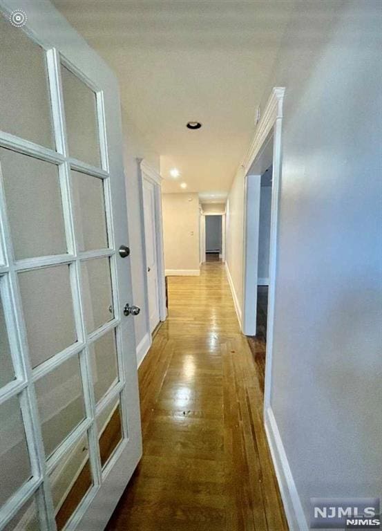 hallway with hardwood / wood-style floors