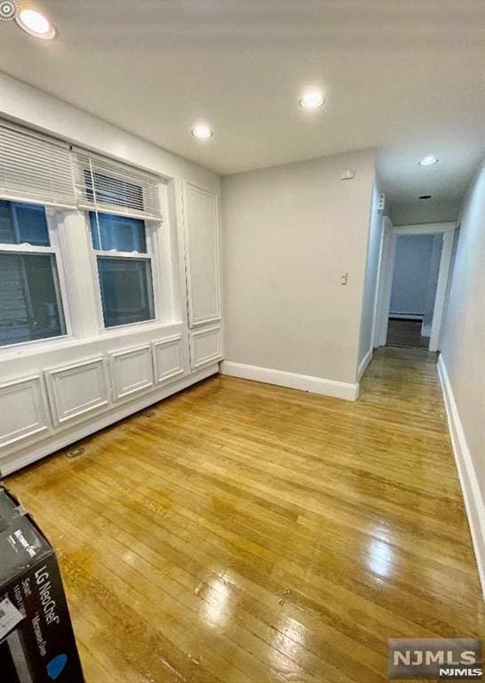 unfurnished room with light wood-type flooring