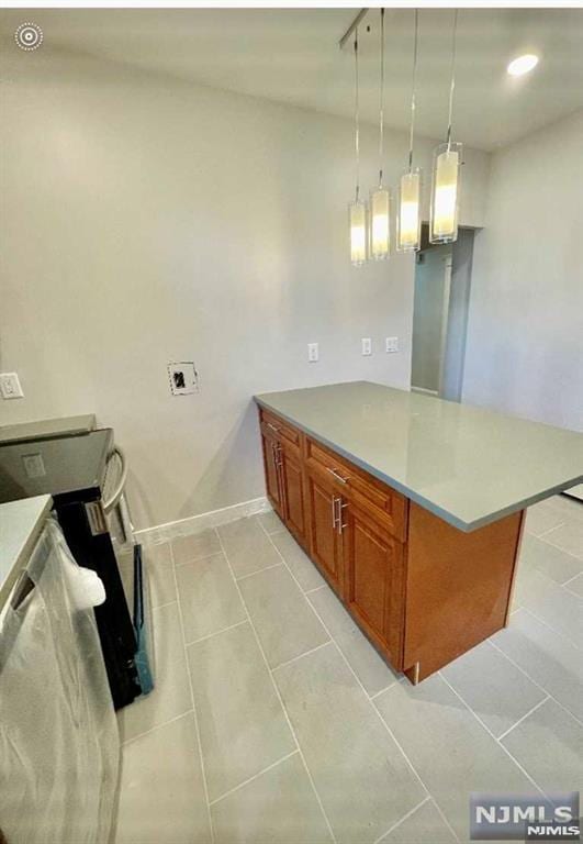 kitchen with pendant lighting, stainless steel range with electric stovetop, light tile patterned flooring, and kitchen peninsula