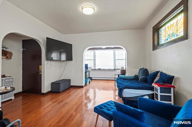 living room with hardwood / wood-style flooring and a baseboard radiator