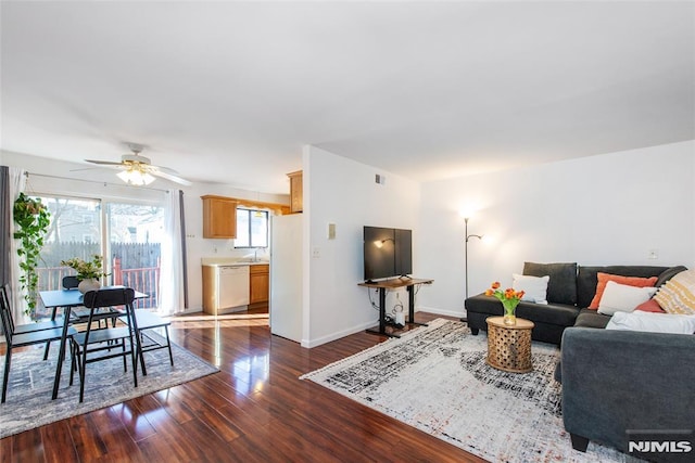 living room with ceiling fan and dark hardwood / wood-style floors