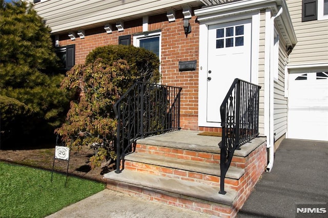 view of exterior entry featuring a garage