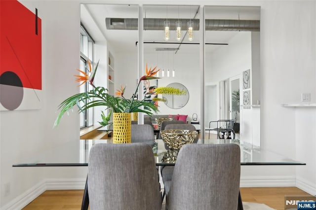 dining room with wood-type flooring