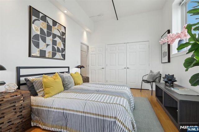 bedroom featuring light hardwood / wood-style floors and a closet