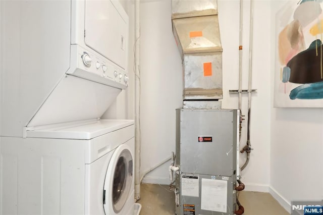 clothes washing area featuring stacked washer and clothes dryer