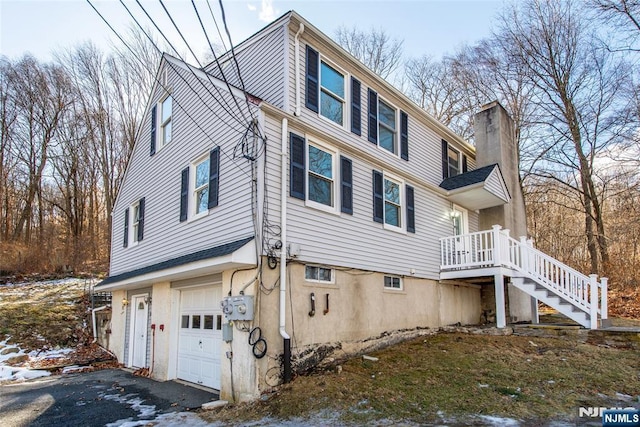 view of snowy exterior featuring a garage