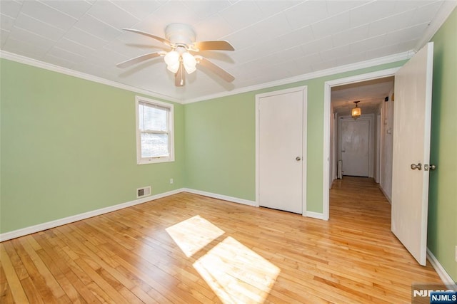 unfurnished bedroom with crown molding, ceiling fan, and light hardwood / wood-style floors