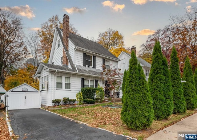 view of front of home with a garage and an outdoor structure