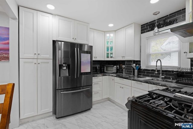 kitchen with white cabinetry, black gas range, stainless steel refrigerator with ice dispenser, tasteful backsplash, and dark stone counters