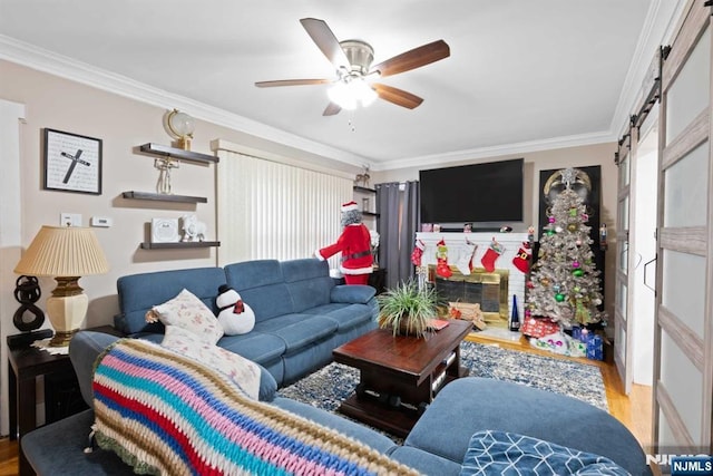 living room featuring ceiling fan, ornamental molding, and light hardwood / wood-style floors